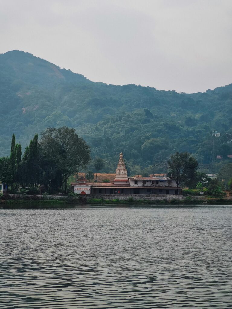 Majestic Indian temple with intricate architecture set against a stunning mountain backdrop