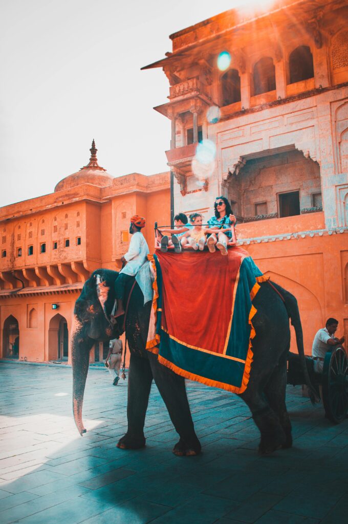 Foreign tourists riding an elephant in India, highlighting cultural heritage and wildlife adventures